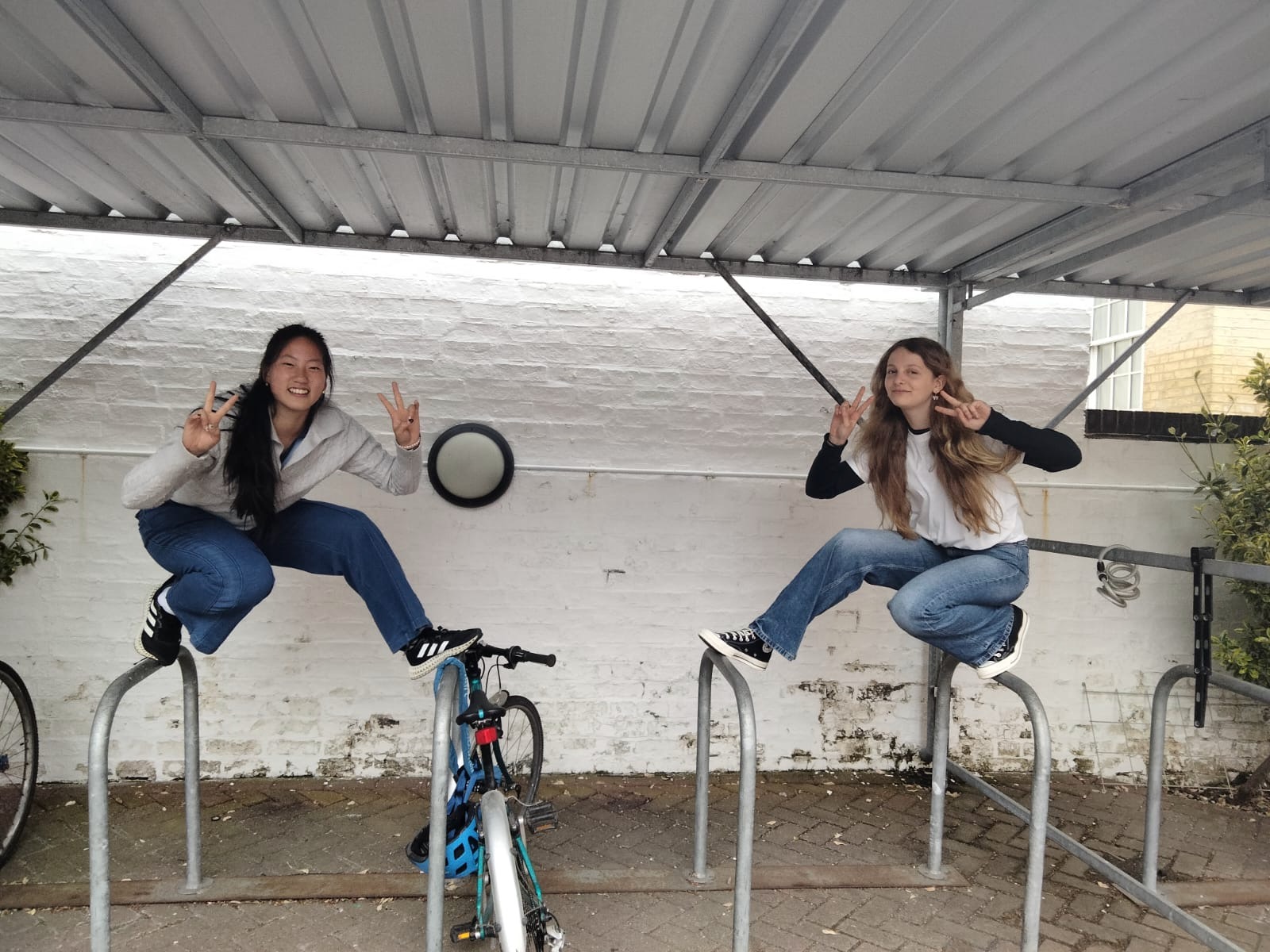 me and my friend standing on a bike rack at 'cool as hack' hackathon